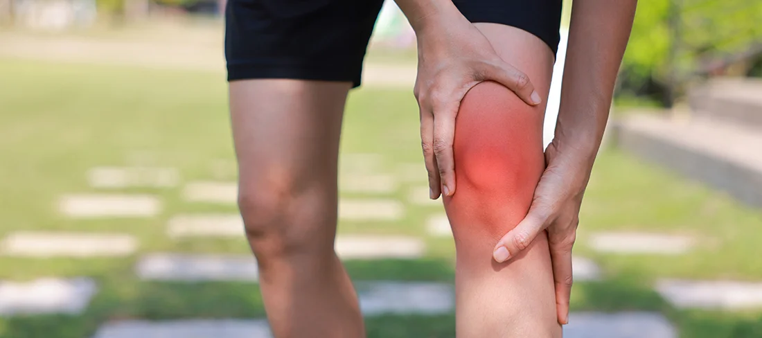 Physiotherapist assisting a patient with leg stretching exercises