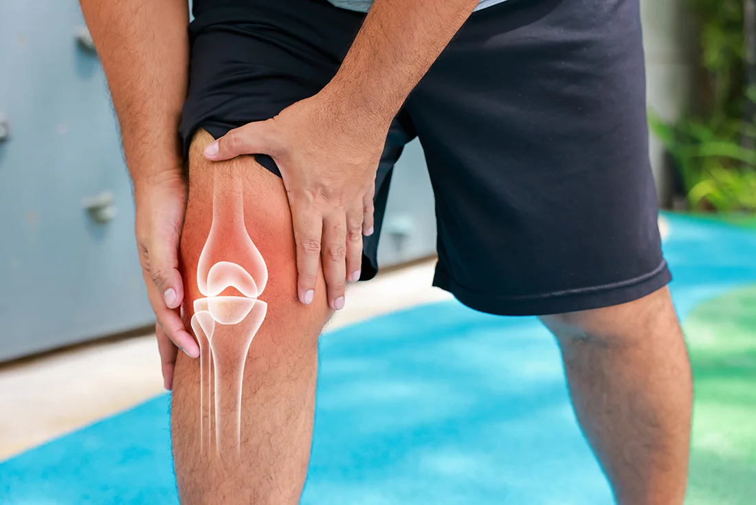 Man holding his knee due to knee pain