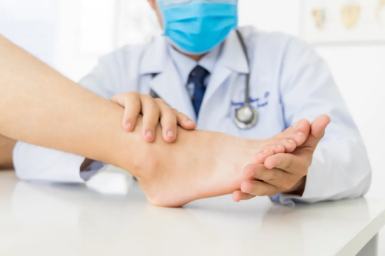 Orthopedic surgeon examining patient’s foot
